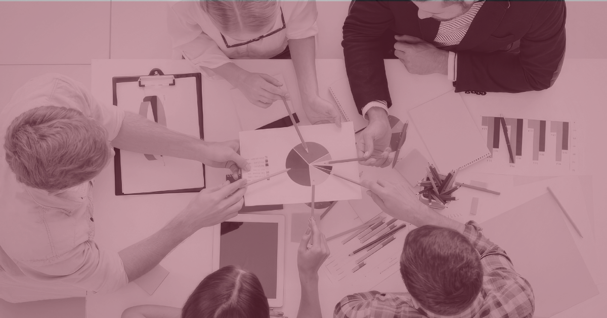 Marketing team collaborating on content strategy and performance analysis to build authority and improve search visibility in AI-driven search environments.