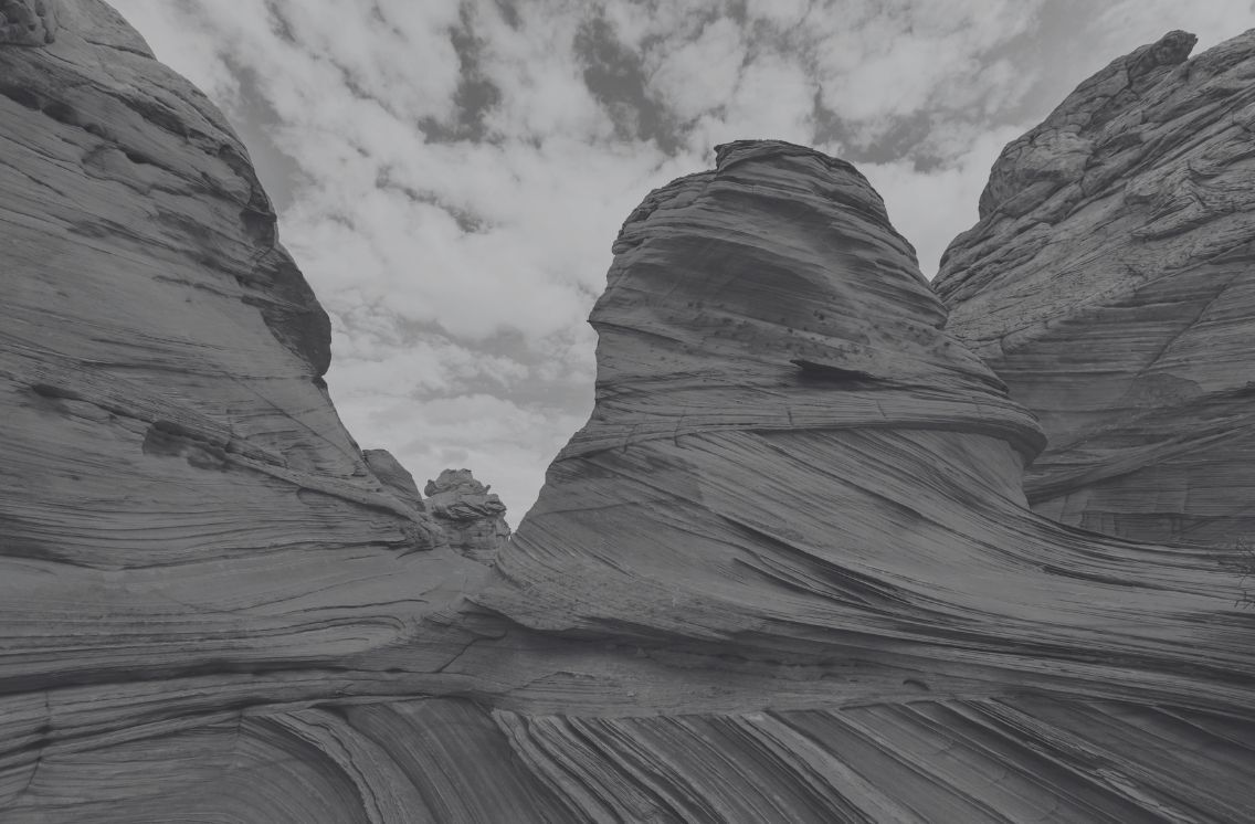 Layered sandstone rock formations under a partly cloudy sky — symbolizing strength, adaptability, and the modern digital marketing foundation of ProIQ